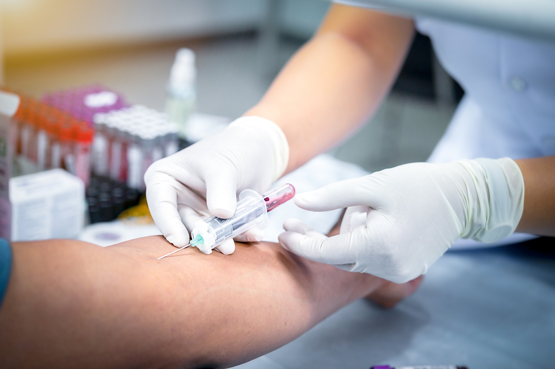 taking blood sample from a patient in the hospital.